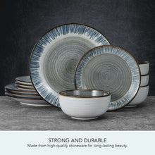 Gray stoneware dinnerware set with blue speckled plates and stacked bowls