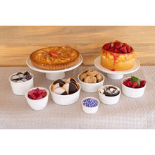 Two-tier white cake stand holding assorted desserts on the tiers