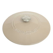 Enamel Dutch oven lid underside with embossed logo, light taupe.