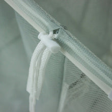 Mesh bag top closure tied around the laundry sorter cart frame bar