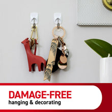 White wire hooks on a wall holding keys, cards, and small accessories