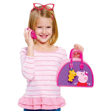 Girl holding a purple Peppa Pig character purse with pink handle