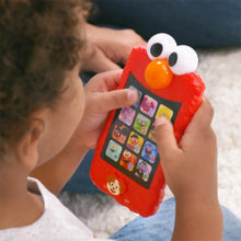 Red Elmo learning phone held in hand, with white eyes and orange nose