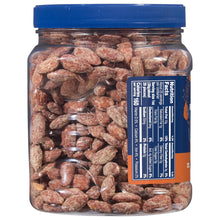 Clear jar of maple brown sugar almonds showing the nutrition label and blue lid