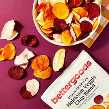 Heirloom veggie chips spread on platter beside bettergoods pouch with mixed chip pieces