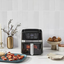 Black digital air fryer with front handle and control panel, with snack tray