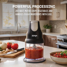 Ninja Express 2-cup food processor on countertop with red puree in clear bowl