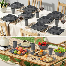 Gray square dinnerware set on table, plates, bowls, cups and utensils