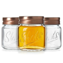 Mini mason jar shot glasses with copper lids, clear jars and one amber-filled jar