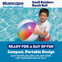 Child holding a small rainbow inflatable beach ball with purple valve and rainbow panels.
