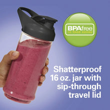 Portable personal blender with pink smoothie in clear jar and sip-through travel lid