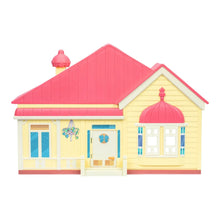 Pink and cream toy playset house with roof detail and front entrance