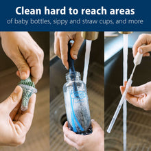 Hands using silicone bottle cleaning brush to scrub a baby bottle, dark blue head