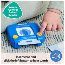 Blue talking flash card reader with large yellow side button, held by hand