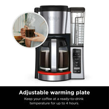 Black Ninja coffee maker with adjustable warming plate and coffee mugs