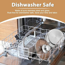 Stainless saucepans with glass lids in dishwasher rack, ready for cleaning