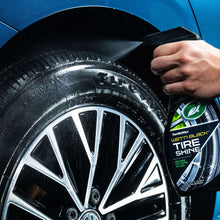 Wheel and tire being treated with TurtleWax Tire Shine spray bottle