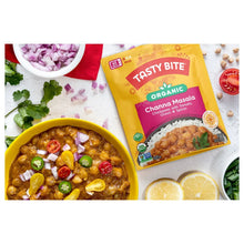 Channa masala chickpea curry in a bowl next to Organic Channa Masala pouch