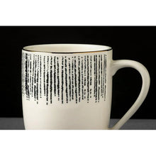Stoneware mug with black drip pattern band and white handle