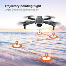 Black quadcopter drone with front dual camera and four rotors, blue status lights