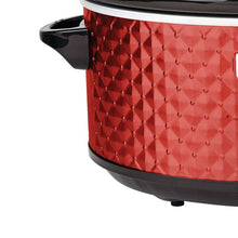 Red slow cooker side with diamond-pattern exterior and black corner handles.