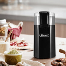 Black electric coffee grinder with transparent lid on kitchen countertop
