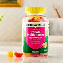 Prenatal multivitamin gummy bottle with assorted fruit gummies visible in glass