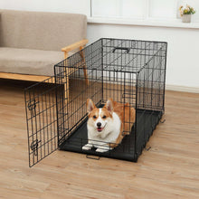 Black metal wire dog crate with open divider section and dog sitting inside on tray