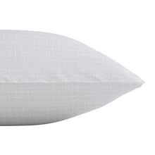 Close-up of white bed pillow, grid-texture cover and rounded end