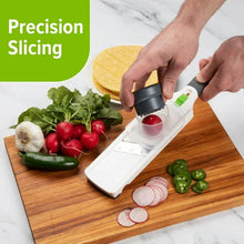 Mini mandoline slicer with dark hand guard and green adjuster bar
