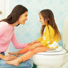 Potty seat with built-in side handles on toilet, light-colored