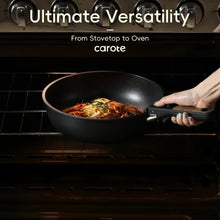 Black nonstick frying pan on a stovetop with cooked food inside and a side handle