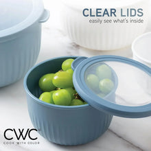 Blue-gray ribbed meal prep bowl with clear lid showing green produce