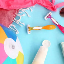 Assorted women’s razors with colorful handles on fabric