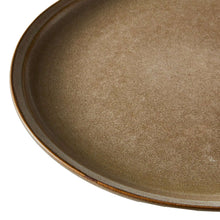 Close-up of brown stoneware dinner plate rim and speckled glaze