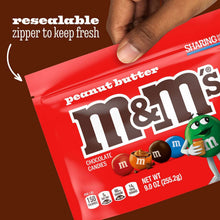 Peanut butter chocolate candy bag with resealable zipper, held by hand