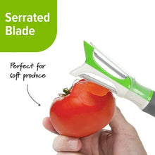 Dual-sided peeler with serrated blade, green and white head, used on tomato