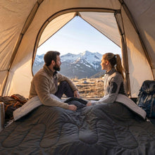 Double sleeping bag in dark gray, open in a camping tent