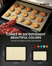 Black silicone baking mat on a baking tray with cookies arranged in rows.