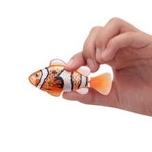 Orange robotic fish with patterned body held in a hand