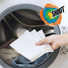 White dye-trapping laundry sheet placed into washer drum with clothes