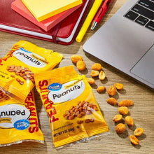 Honey-roasted peanuts pouches with scattered roasted peanut pieces on tabletop