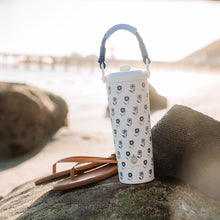 Stainless steel water bottle with blue paracord handle, white body with blue floral print