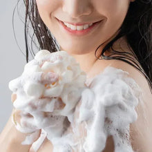 Body wash foam on skin with a smiling person in shower