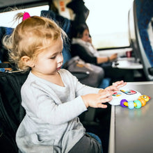 Toddler in car holding musical take-along toy with colorful bead chaser and lighted screen