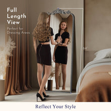 Full-length arch floor mirror leaning view with ornate filigree frame and beaded border