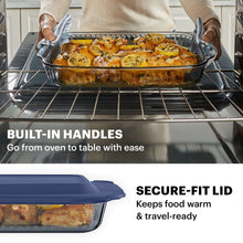 Smoke-tinted glass baking dish with lid and built-in handles, lifted from oven