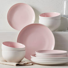 Blush stoneware dinnerware set with stacked plates and bowls, glossy glaze