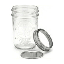 Regular-mouth clear mason jar with metal lid and band, embossed design