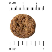 Round brown omega-3 dog soft chew with size ruler markings
